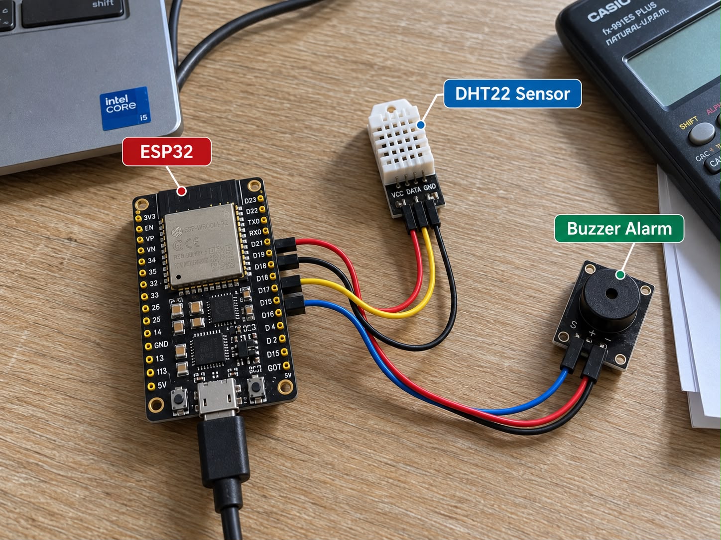 ESP32 DevKit V1 wired to a DHT22 sensor and an active buzzer module